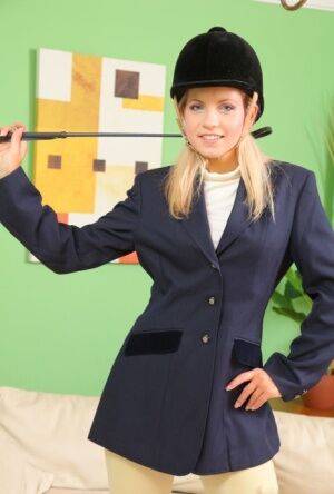 Young blonde Jenni P removes riding attire to model topless in pantyhose on nudesceleb.com