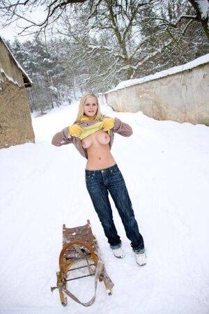 Busty blonde bares big tits in the snow & sucks POV for mouthful of cum on nudesceleb.com