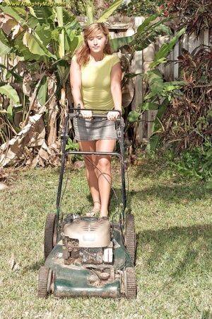 Curvy May Malani gets horny mowing the lawn so she gets naked. on nudesceleb.com