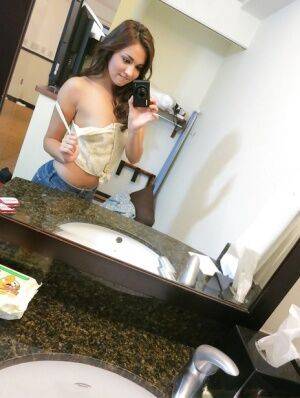 Sassy brunette stripping in front of the mirror and making selfies on nudesceleb.com