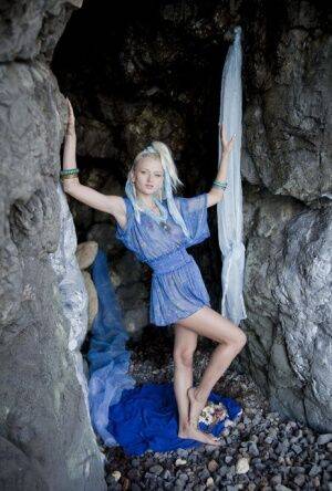 Young looking blonde Nika N finger fucks in a cave before blowing a kiss on nudesceleb.com