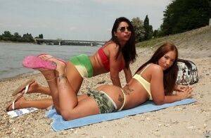 Lesbian babes Kyra Hot and Candy Coxx are having amazing time outdoor on nudesceleb.com