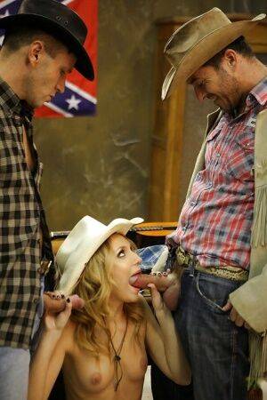 Slippy blonde cowgirl has some double penetration fun with two hung lads on nudesceleb.com