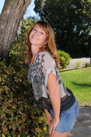 Redhead MILF Sophia K removes jean shorts as she disrobes under patio tree on nudesceleb.com