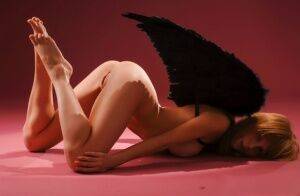 Barely legal girl Hypatia K sports dark angel wings while modeling in the nude on nudesceleb.com