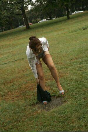 Amateur chick Dirty Angie strips to her pretties and tan nylons in a park on nudesceleb.com