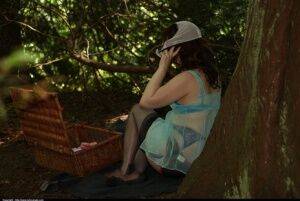 Brunette dons retro underwear while wearing nylons and lingerie in the woods on nudesceleb.com