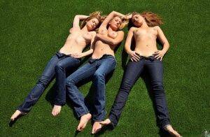 3 topless girls pull their blue jeans down over their bare asses on the lawn on nudesceleb.com