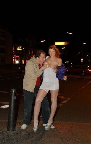 Slutty LaMia in white stockings topless sucks on her knees in the street on nudesceleb.com