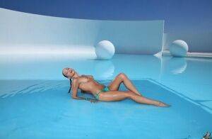 Lovely girl in glasses and bikini Celeste Star enjoys swimming in pool on nudesceleb.com