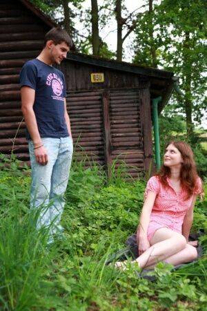 Young redhead and her boyfriend have sex outside a cabin in the woods on nudesceleb.com