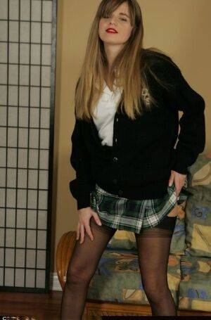 Naughty schoolgirl taking off her uniform and posing in lingerie on nudesceleb.com