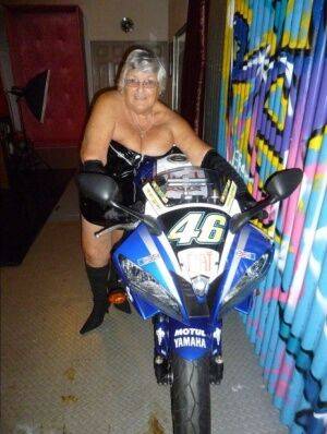 Old fatty Grandma Libby strips to black boots on top of a motorcycle on nudesceleb.com