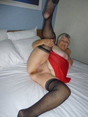 Fat man Grandma Libby doffs her lingerie before masturbating on her bed on nudesceleb.com