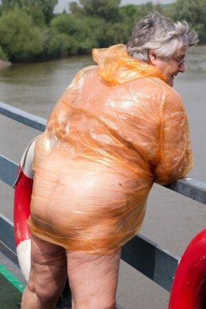 Obese oma Grandma Libby doffs a see-through raincoat to get naked on a bridge on nudesceleb.com
