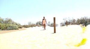 Solo girl Chloe Lamour takes a big piss while crossing a patch of sand on nudesceleb.com