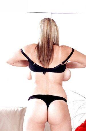 Blonde European MILF pornstar Kelly Kay unleashing huge boobs from lingerie on nudesceleb.com