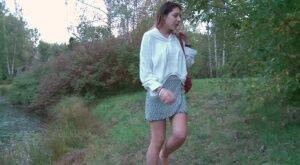 Brunette cutie squats to piss near the lake on nudesceleb.com