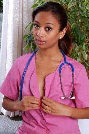 Amateur black babe bares shaved teen pussy after shedding nurse uniform on nudesceleb.com