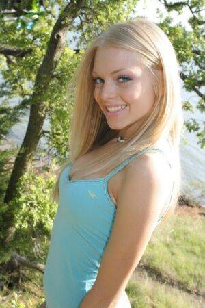 Cute blonde teen Skye Model drops her shorts lakeside to pose in white panties on nudesceleb.com