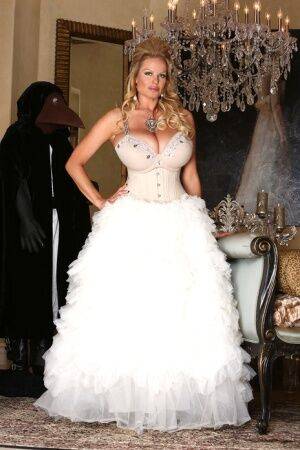 Blonde chick Kelly Madison releases her big tits from her white gown on nudesceleb.com
