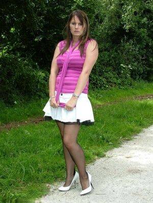 Outdoor posing from an non nude model Cathy in her white high heels on nudesceleb.com