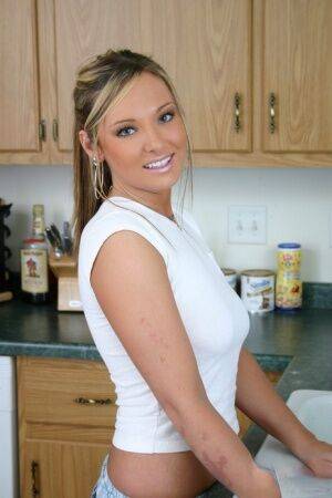 Horny girlfriend wets her white shirt in the kitchen showing her perky tits on nudesceleb.com