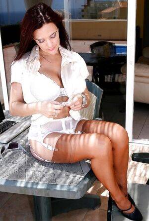 Sunglasses adorned brunette lady flashes upskirt white panties on nudesceleb.com