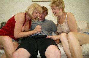 Two blonde grannies share a horny student's hard white dick on the sofa on nudesceleb.com