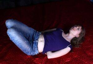 Barefoot white girl Agnes is hogtied in a shirt and blue jeans on nudesceleb.com