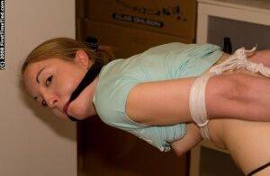 White girl is tied up and cuffed while ball gagged with pants pulled down on nudesceleb.com