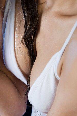 Gorgeous teen Sandra Lauver removes a white dress while getting wet on nudesceleb.com