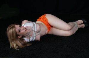 White girl with perky tits is blindfolded after being hogtied in shorts on nudesceleb.com