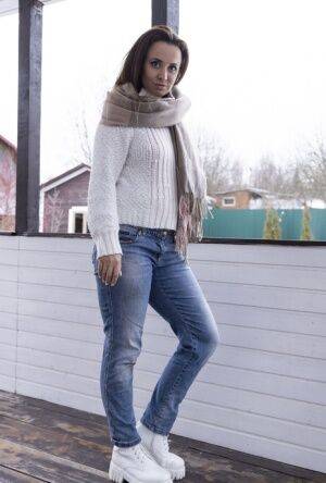 Kamilla is outside in the cold in her white sweater and denim jeans She enjoys on nudesceleb.com