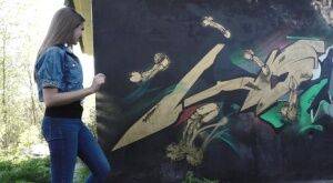 White girl Viktoria pulls down her jeans to take a pee near a wall of graffiti on nudesceleb.com