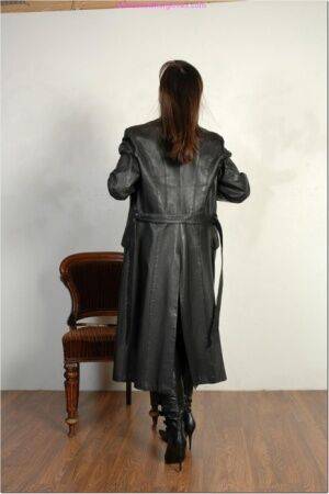 Brunette female dons long leather coat in leather boots and stockings on nudesceleb.com