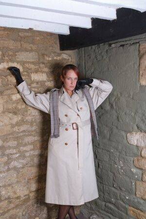 Redhead woman Sammy frees her small tits from trench coat in leather gloves on nudesceleb.com