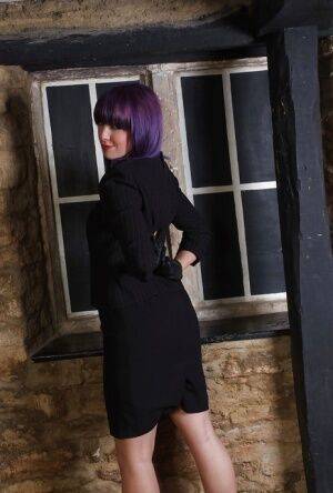 Pretty chick with purple hair poses fully clothed in black dress and pumps on nudesceleb.com