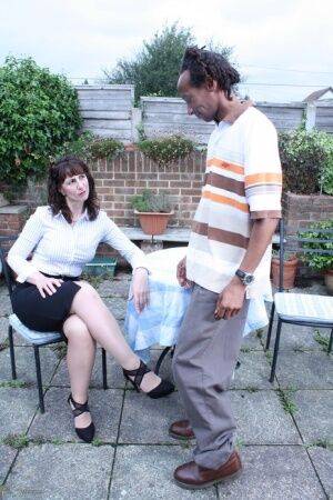 Cheating UK housewife seduces a black man in a black skirt on patio - Britain on nudesceleb.com