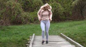 Blonde Katy Sky shows her bald beaver while squatting outside for a pee on nudesceleb.com
