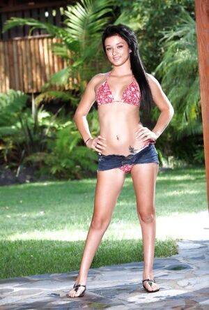 Perky latina hottie in daisy duck shorts uncovering her slim curves outdoor on nudesceleb.com