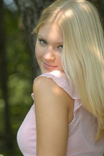 Charming blonde teen Tiffany hikes skirt over cotton panties in the forest on nudesceleb.com