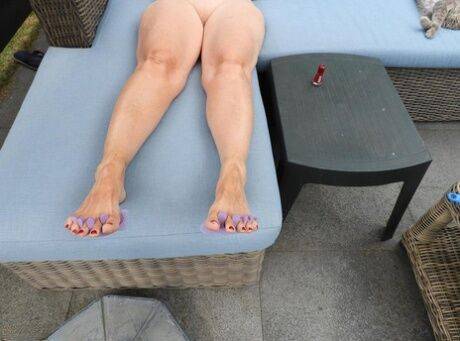 Old woman Kat Kitty gets naked on outdoor sofa while painting her toenails on nudesceleb.com