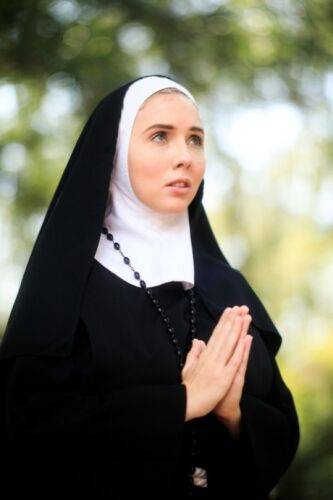 Thick Nun exposes herself in the courtyard wearing over the knee socks on nudesceleb.com