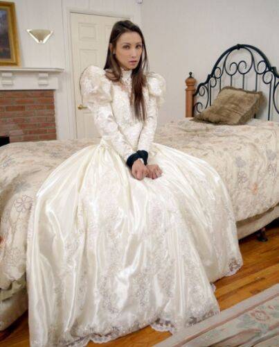 Brunette bride Celeste Star is ballgagged and tied up in her wedding dress on nudesceleb.com