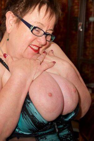 Obese mature woman exposes her big tits and pussy with her glasses on on nudesceleb.com