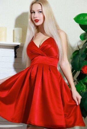 Nice blonde teen Genevieve Gandi removes red dress to display her trimmed muff on nudesceleb.com