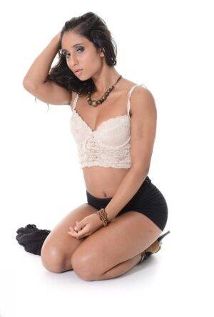 Hot Latina girl Ria Rodriguez gets naked before masturbating with a vibrator on nudesceleb.com