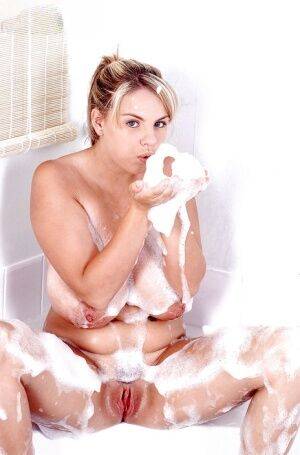 Plump Euro babe Kelly Kay soaps up huge pornstar juggs in bathtub on nudesceleb.com