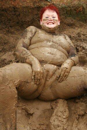 Older redhead Valgasmic Exposed rolls around in a mud pit while totally naked on nudesceleb.com